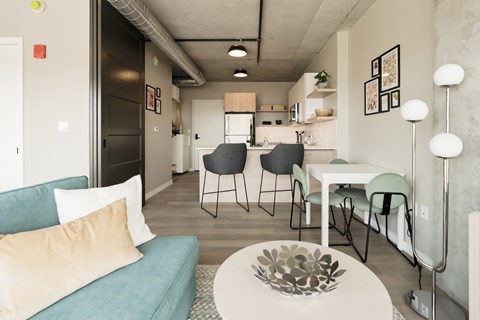 a living room and dining room with a couch and a table